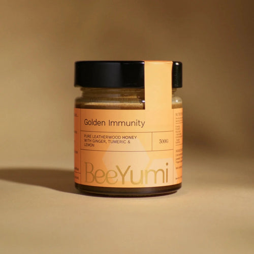 Jar of BeeYumi Golden Immunity on a beige background
